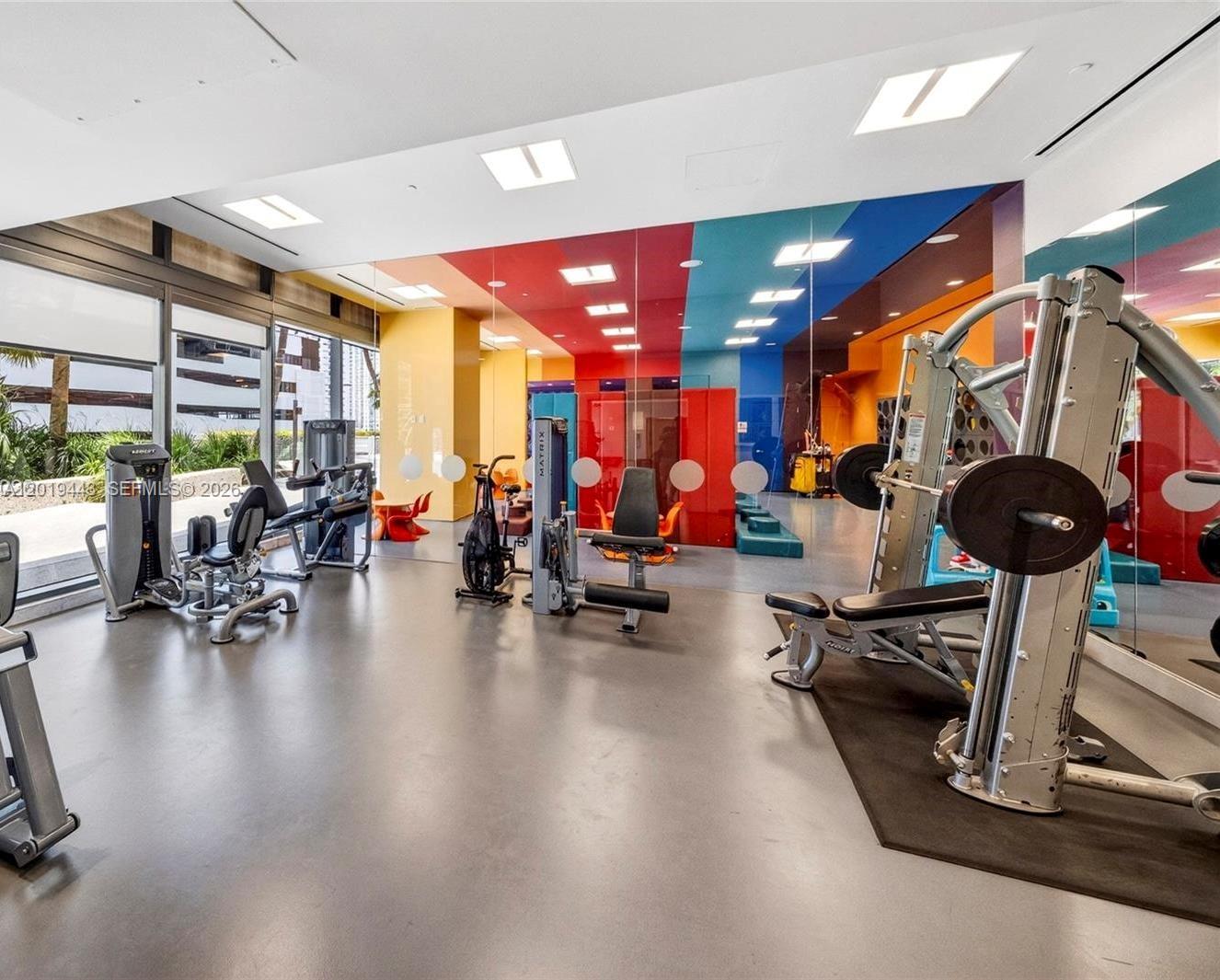 68 Southeast 6th Street, Unit 2702 Miami, FL 33131 - Photo 26 of 28 a view of a room with gym equipment