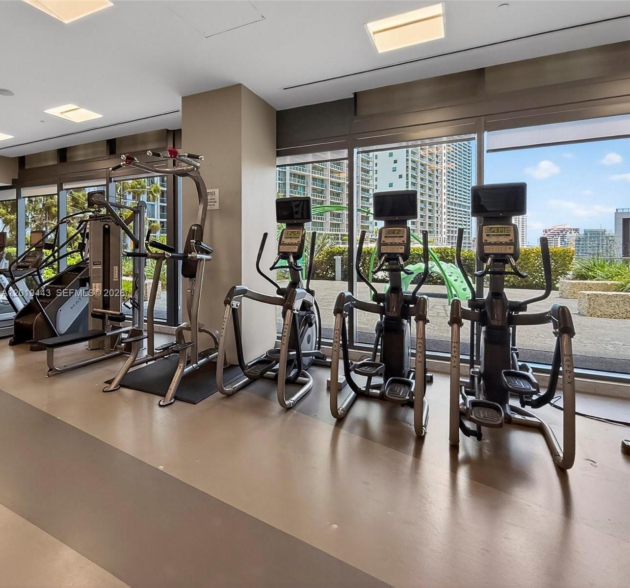 68 Southeast 6th Street, Unit 2702 Miami, FL 33131 - Photo 27 of 28 a view of a room with gym equipment