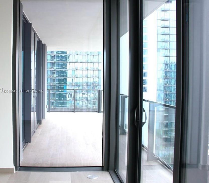 68 Southeast 6th Street, Unit 2702 Miami, FL 33131 - Photo 6 of 28 a view of a glass door with a view of balcony