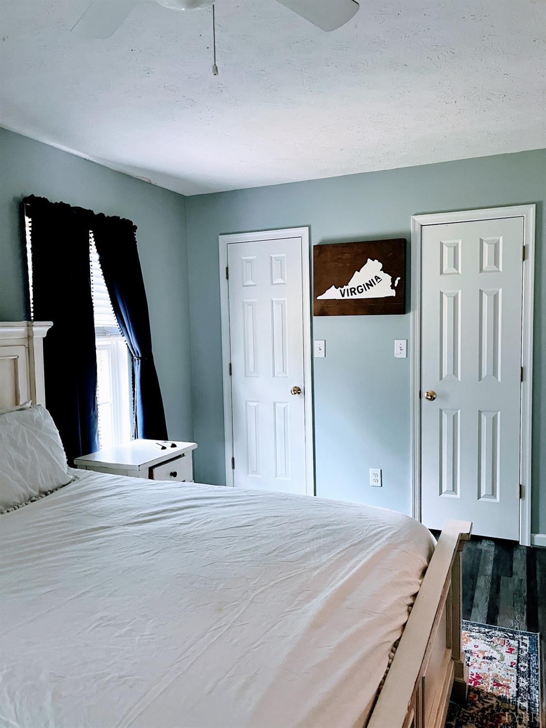 1069 Blue Ridge View Circle Forest, VA 24551 - Photo 11 of 12 a bedroom with a bed and a painting on the wall