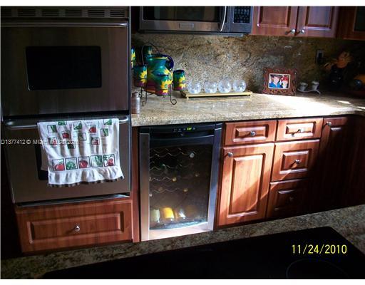 5205 Alton Road Miami Beach, FL 33140 - Photo 11 of 16 a kitchen with stainless steel appliances granite countertop a stove and a microwave