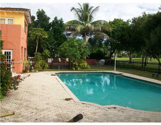 5205 Alton Road Miami Beach, FL 33140 - Photo 3 of 16 a view of a swimming pool with a patio