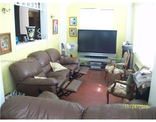 5205 Alton Road Miami Beach, FL 33140 - Photo 4 of 16 a living room with furniture and a flat screen tv