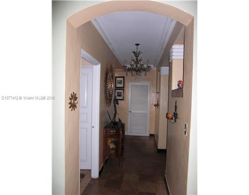 5205 Alton Road Miami Beach, FL 33140 - Photo 8 of 16 a view of a hallway with a dining room