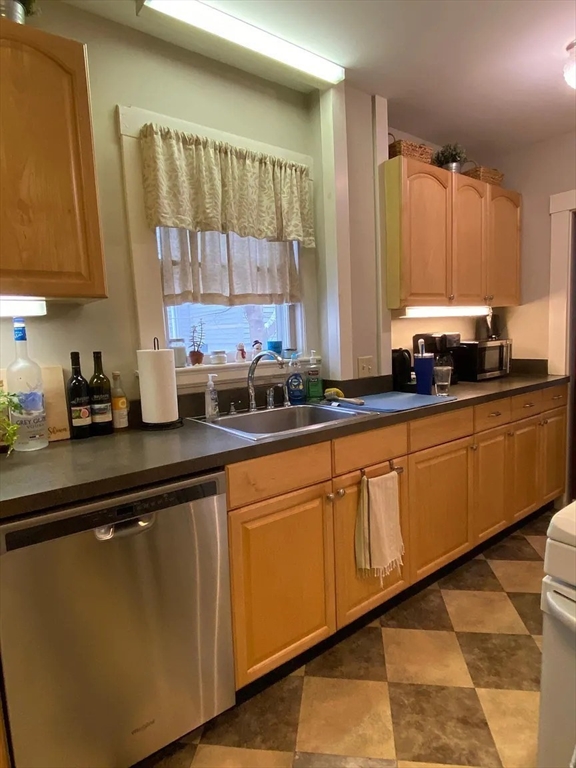 7 High Street, Unit 1 Somerville, MA 02144 - Photo 11 of 13 a kitchen with stainless steel appliances a sink a stove and a window