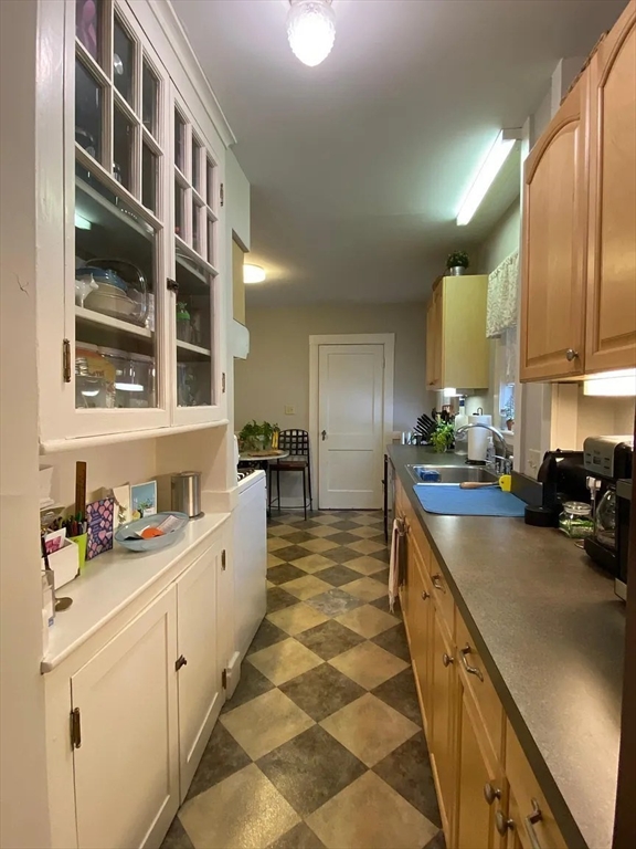 7 High Street, Unit 1 Somerville, MA 02144 - Photo 12 of 13 a kitchen with stainless steel appliances a sink stove and cabinets
