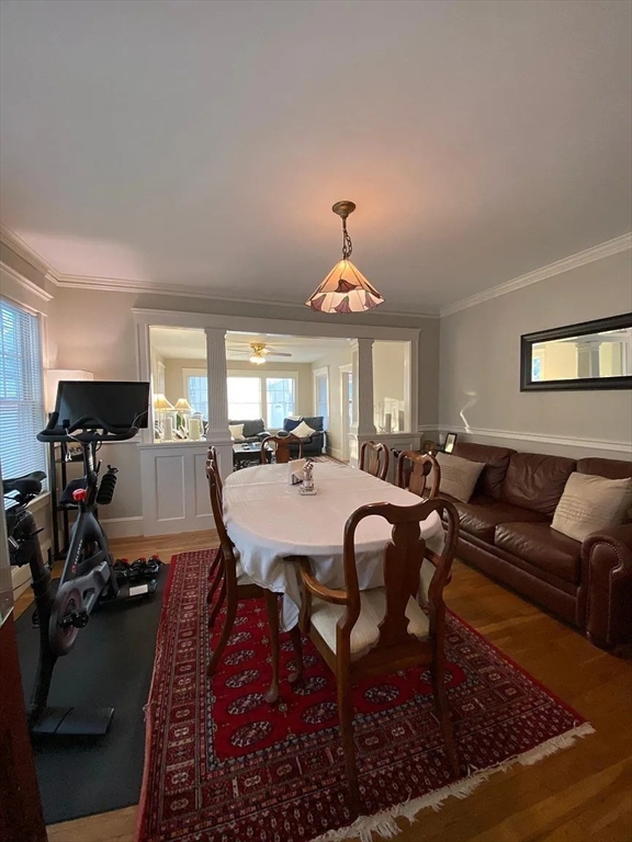 7 High Street, Unit 1 Somerville, MA 02144 - Photo 4 of 13 a living room with furniture a chandelier and a table