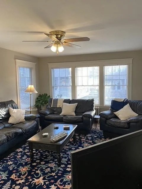 7 High Street, Unit 1 Somerville, MA 02144 - Photo 5 of 13 a living room with furniture and a chandelier