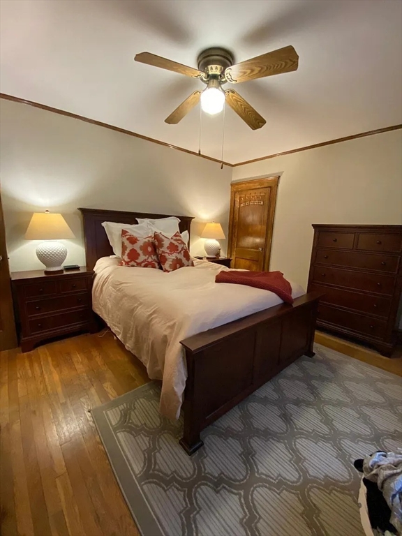 7 High Street, Unit 1 Somerville, MA 02144 - Photo 7 of 13 a bedroom with a bed and a lamp with the wooden floor