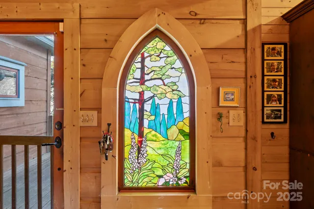 a view of entryway with a front door and wooden floor
