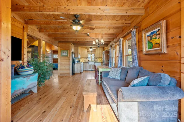 a kitchen with granite countertop wooden floors and white stainless steel appliances