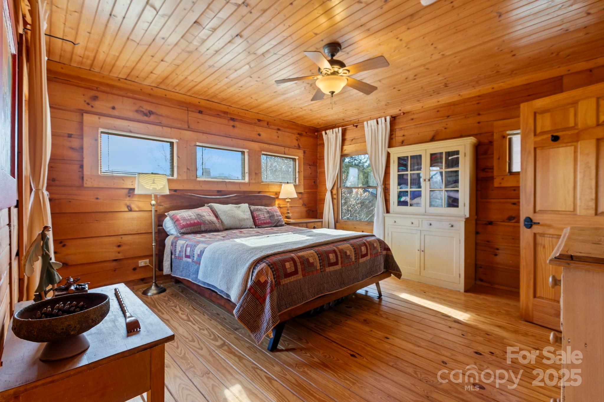 104 Enthoffer Road Black Mountain, NC 28711 - Photo 23 of 42 a bedroom with a bed and a chandelier