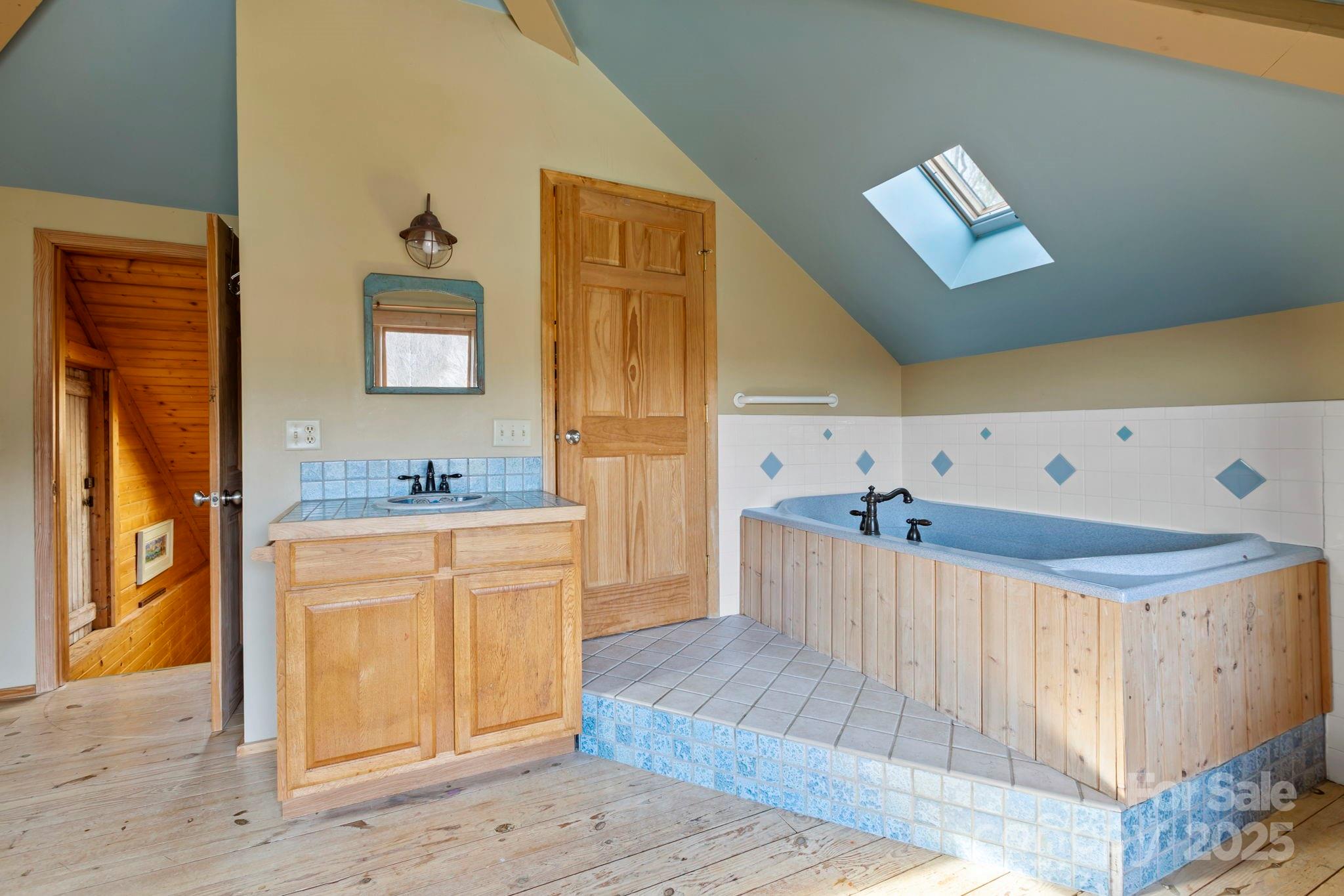 104 Enthoffer Road Black Mountain, NC 28711 - Photo 27 of 42 a spacious bathroom with a granite countertop sink and a mirror