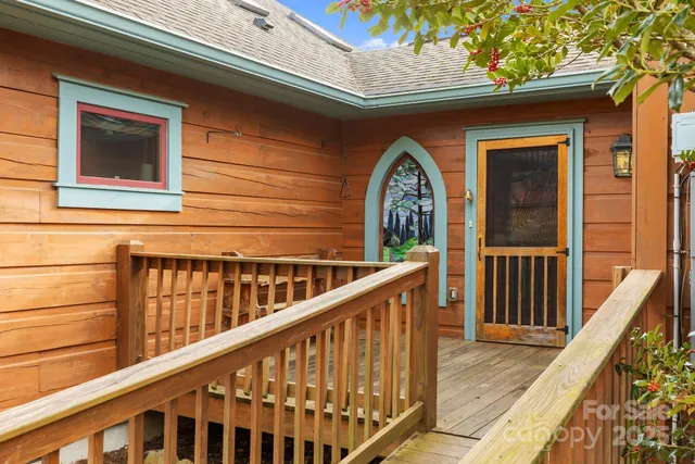 a view of balcony with wooden floor and fence