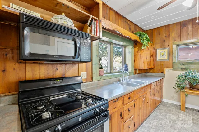 a kitchen with stainless steel appliances granite countertop a stove and a microwave