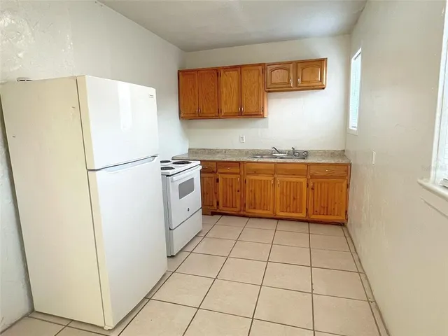 a kitchen with stainless steel appliances a refrigerator sink and cabinets