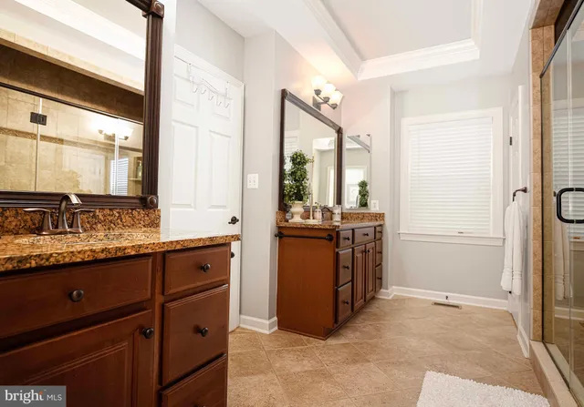 a kitchen with stainless steel appliances granite countertop a stove top oven a sink a dining table and chairs