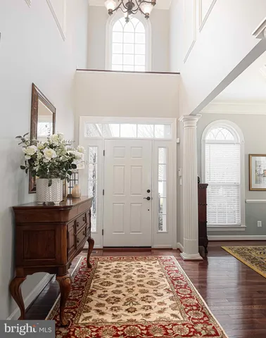 a dining room with furniture a rug and wooden floor