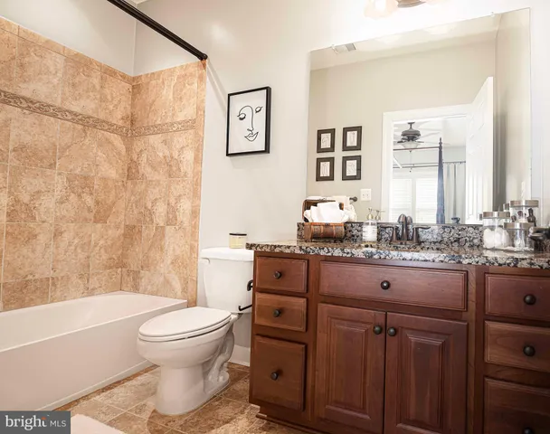 a view of a white house with a big yard and large trees