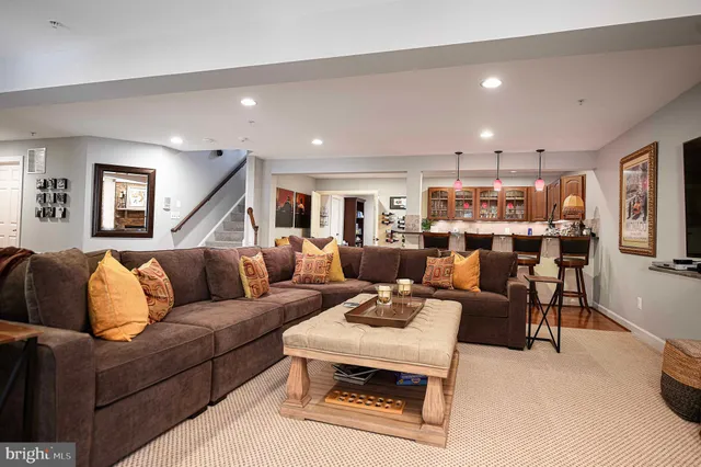 a view of a patio with couches table and chairs and potted plants