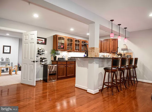 a living room with furniture a fireplace and a chandelier