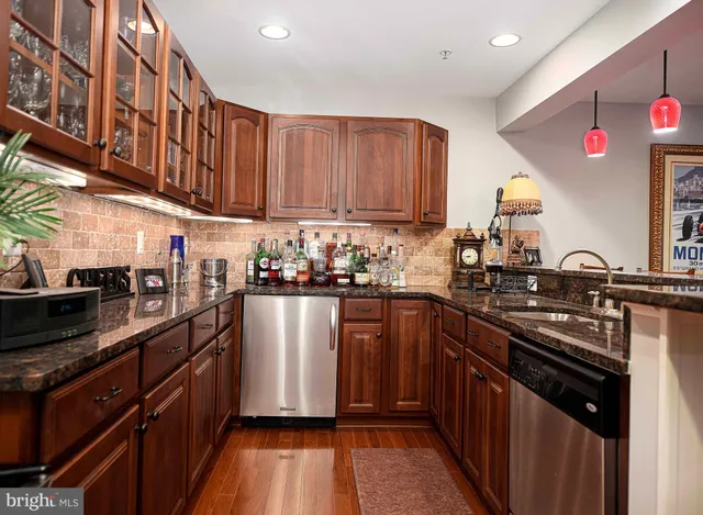 a kitchen with stainless steel appliances granite countertop a stove a sink dishwasher and a refrigerator