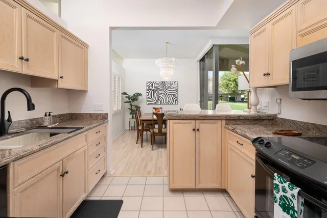 a kitchen with appliances a sink and cabinets