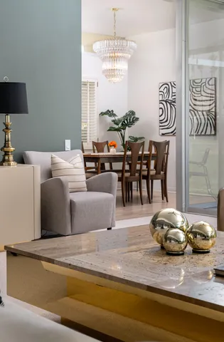 a living room with furniture and a chandelier