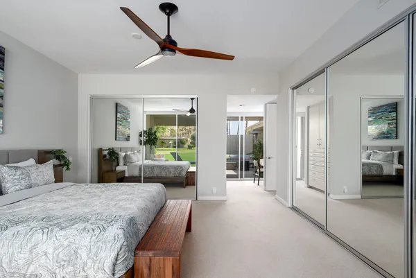a bedroom with furniture and a large window