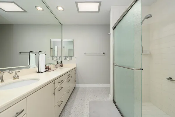 a bedroom with bed and glass window