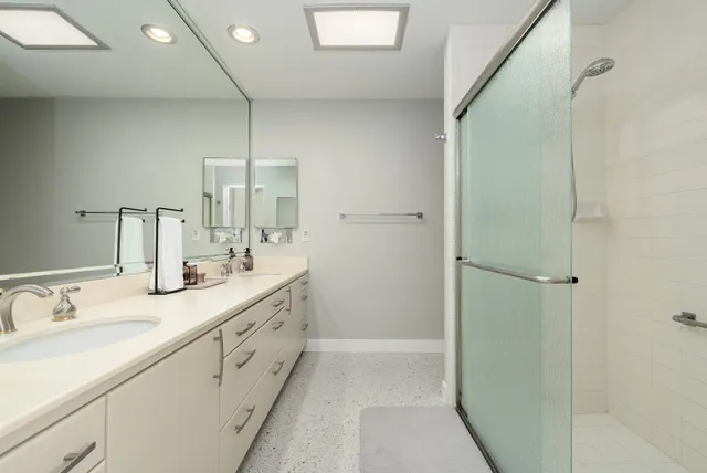 a bedroom with bed and glass window