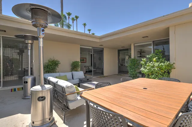 a view of a patio with couches and potted plants