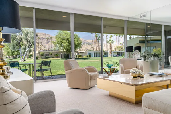 a view of a patio with a table chairs and a backyard