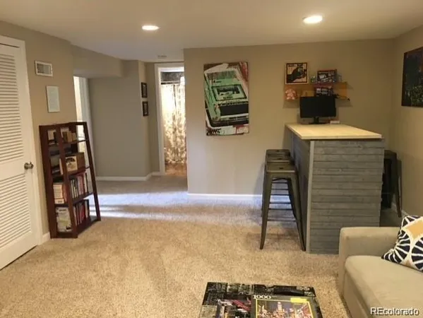 a bedroom with furniture and a flat screen tv