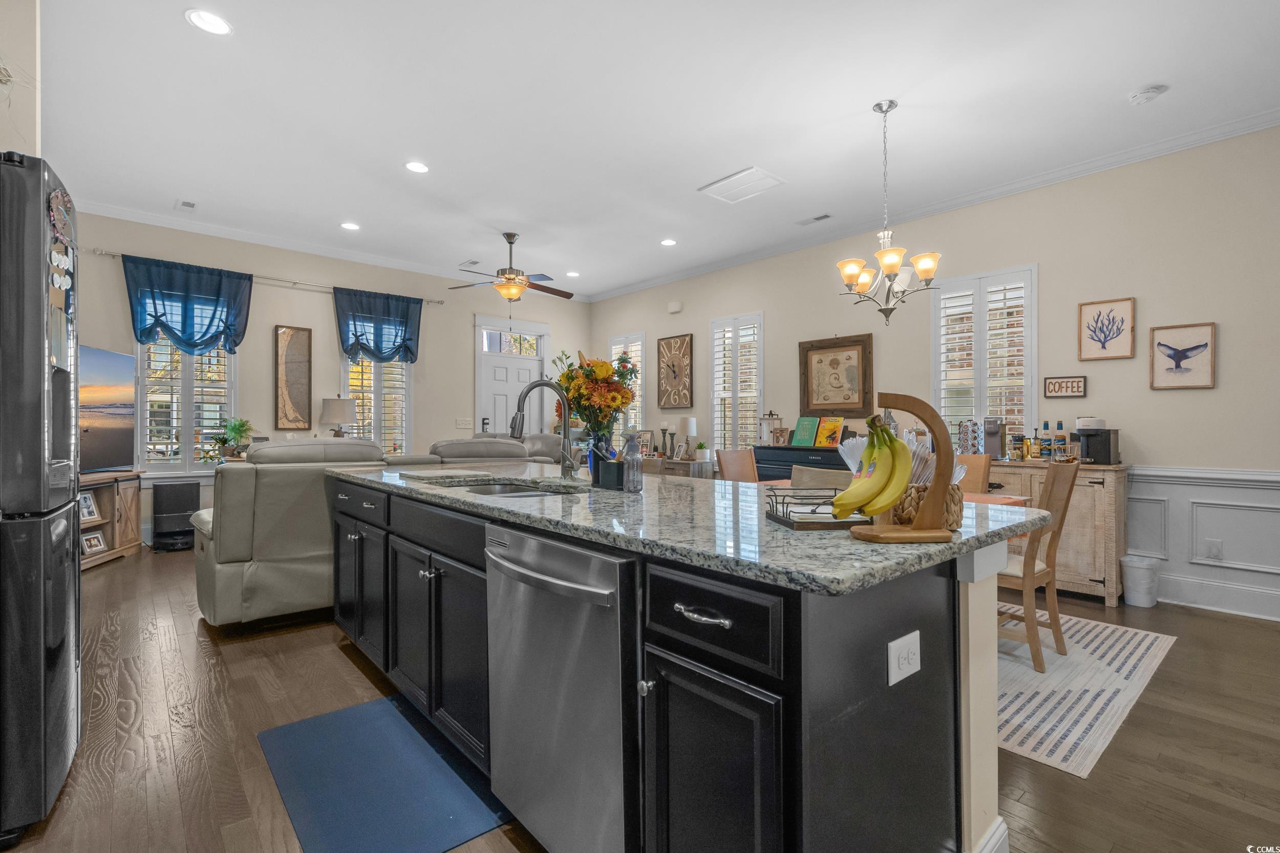 2794E Howard Avenue, Unit A Myrtle Beach, SC 29577 - Photo 40 of 40 Kitchen featuring dark cabinetry, open floor plan, recessed lighting, light stone counters, and freestanding refrigerator
