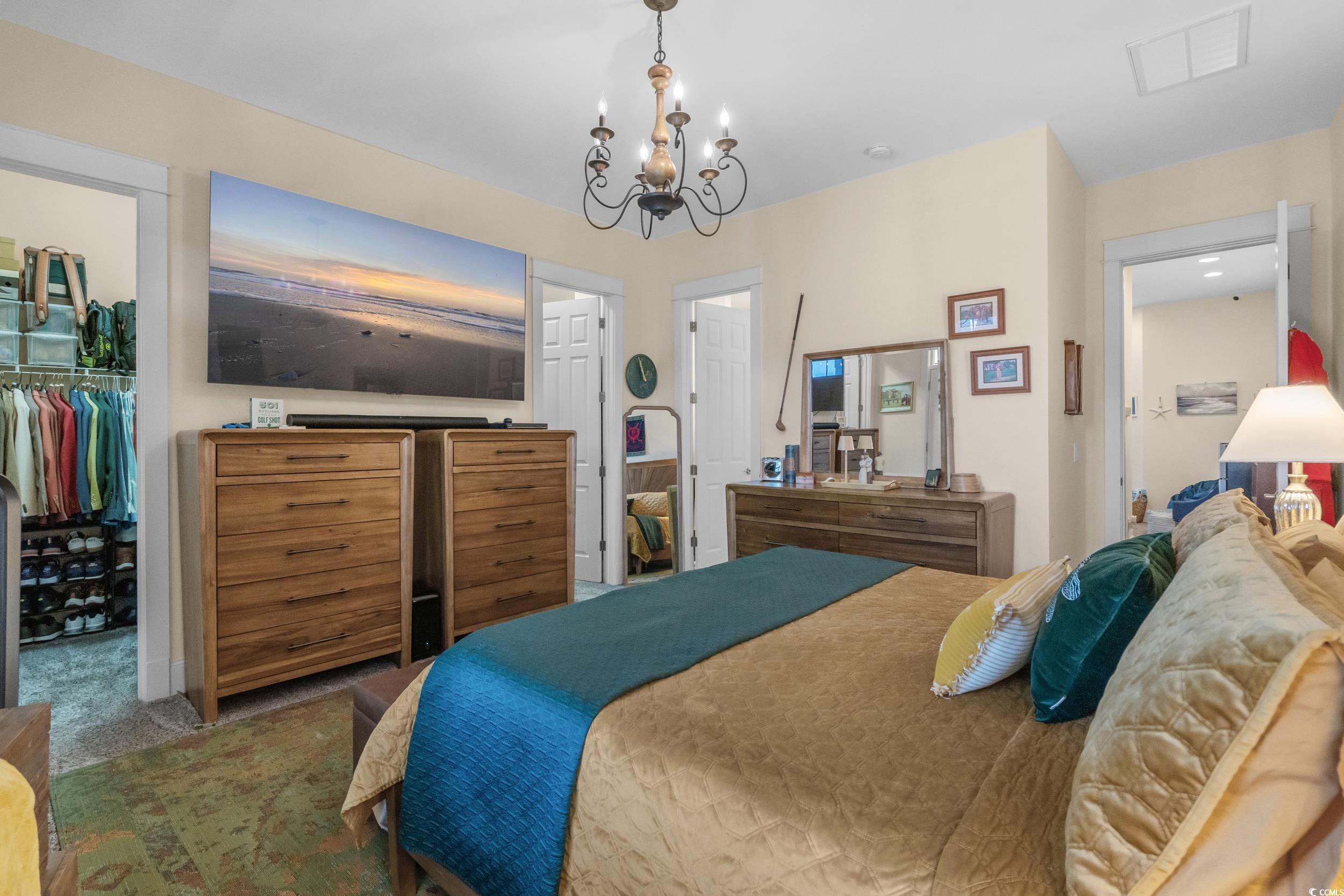 2794E Howard Avenue, Unit A Myrtle Beach, SC 29577 - Photo 18 of 40 Carpeted bedroom featuring a spacious closet and a chandelier