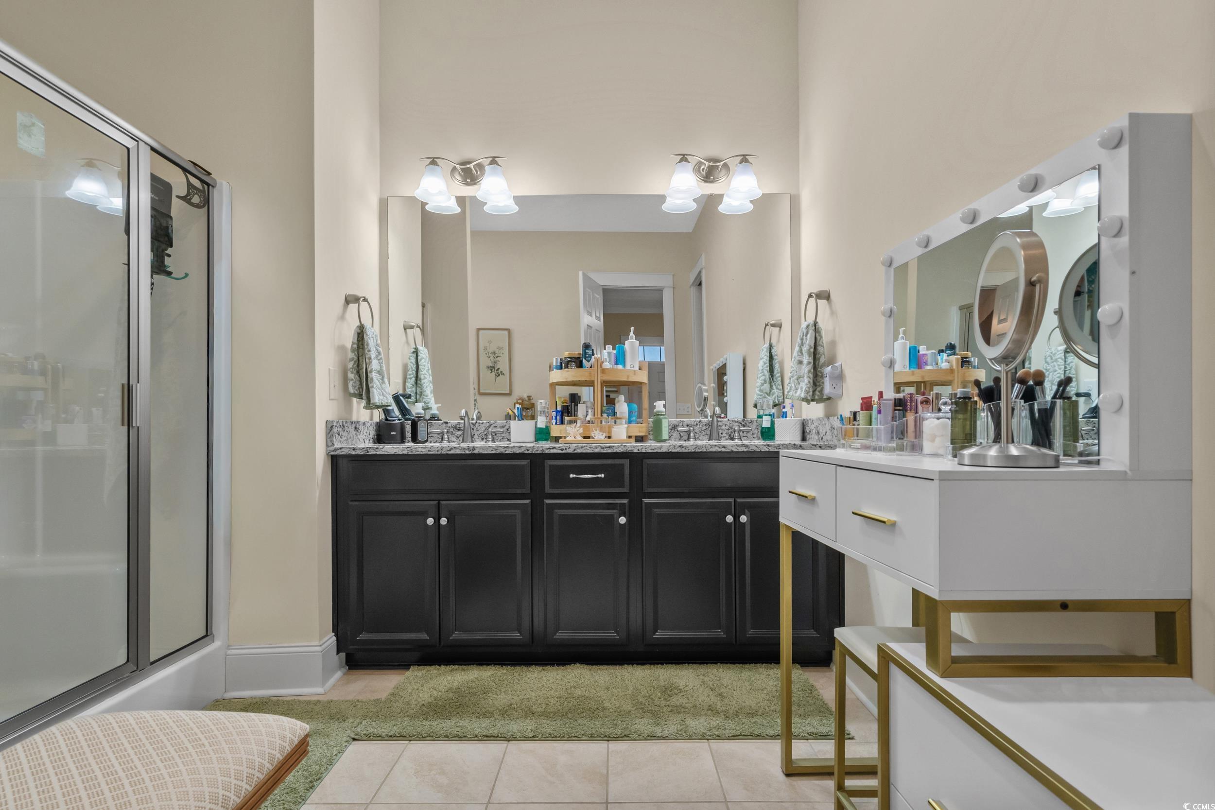 2794E Howard Avenue, Unit A Myrtle Beach, SC 29577 - Photo 19 of 40 Bathroom with double vanity, light tile patterned floors, and a shower stall