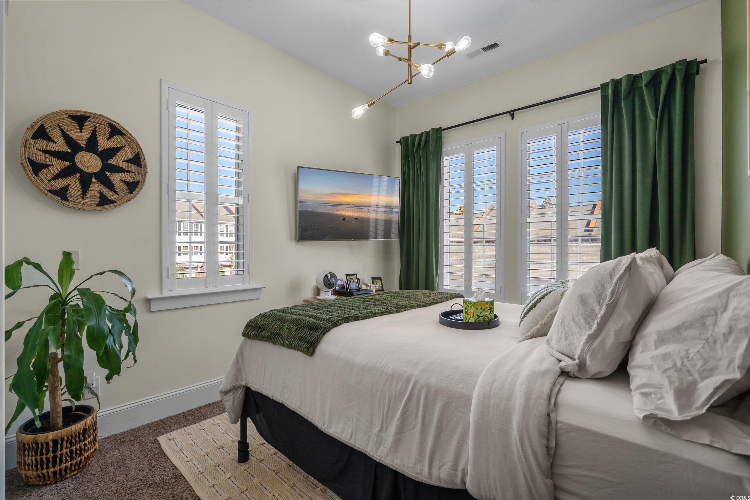 2794E Howard Avenue, Unit A Myrtle Beach, SC 29577 - Photo 24 of 40 Carpeted bedroom with baseboards and a chandelier
