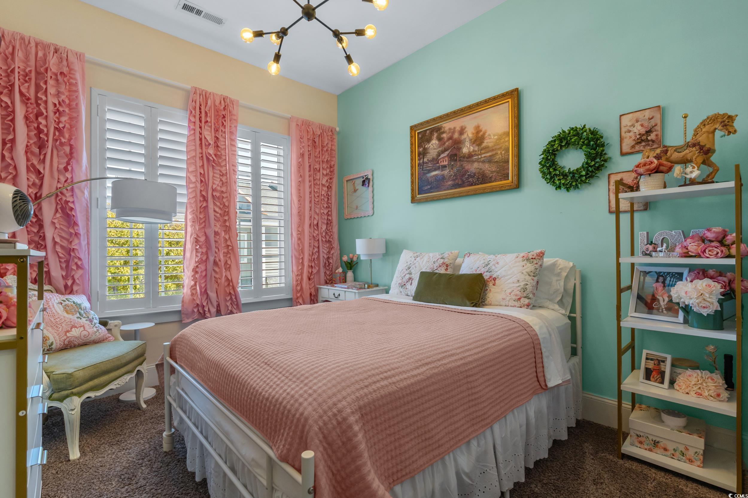 2794E Howard Avenue, Unit A Myrtle Beach, SC 29577 - Photo 25 of 40 Bedroom with a chandelier and dark colored carpet