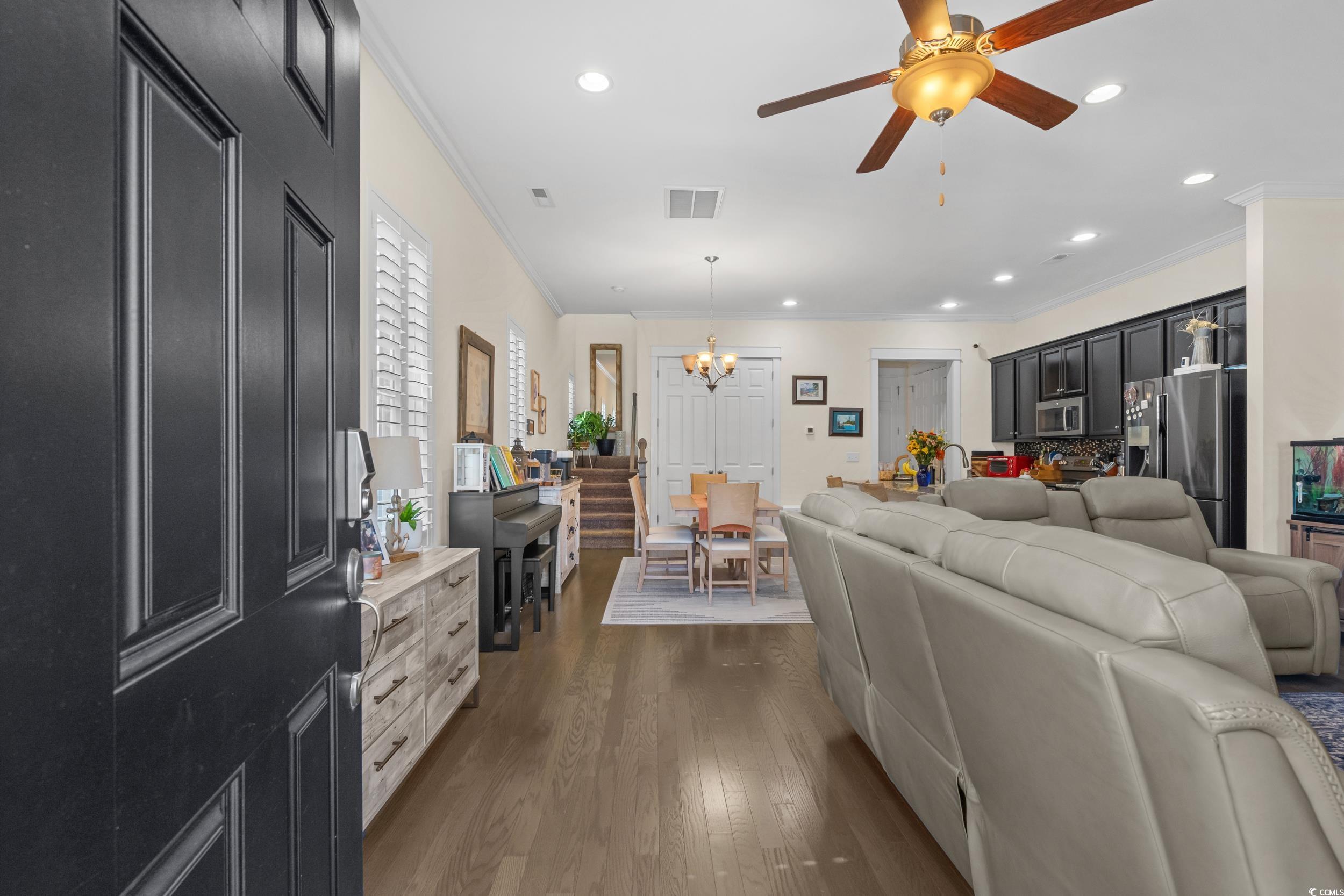 2794E Howard Avenue, Unit A Myrtle Beach, SC 29577 - Photo 5 of 40 Living area with crown molding, recessed lighting, dark wood finished floors, a ceiling fan, and a chandelier