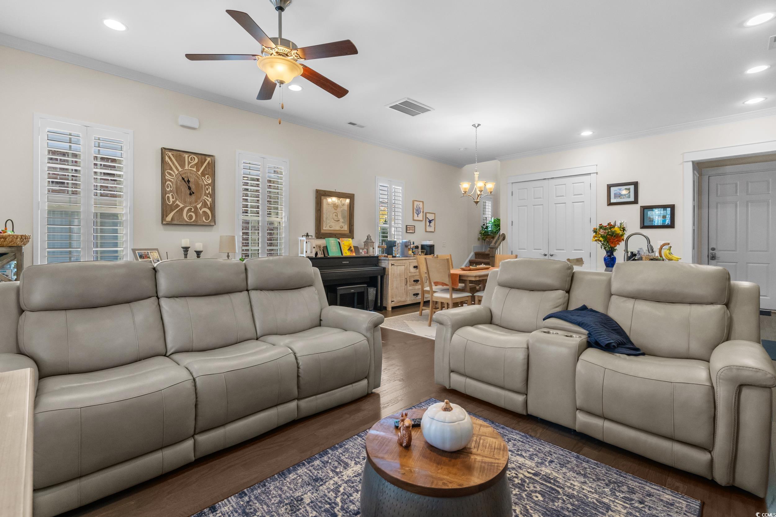2794E Howard Avenue, Unit A Myrtle Beach, SC 29577 - Photo 9 of 40 Living room featuring recessed lighting, crown molding, wood finished floors, a chandelier, and a ceiling fan
