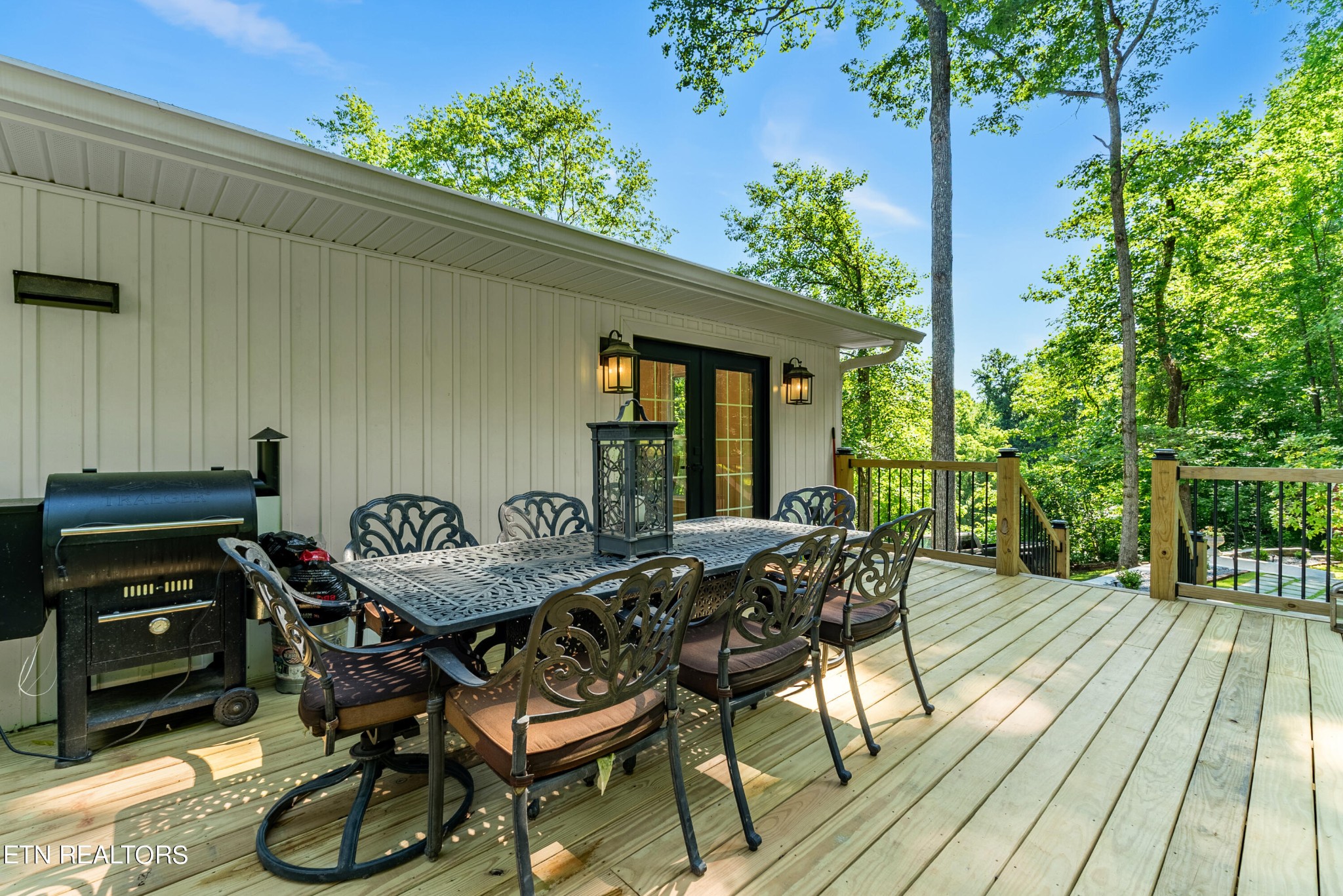 337 Farmer's Hollow Road Clinton, TN 37716 - Photo 13 of 49 a view of a patio with table and chairs with wooden floor and plants