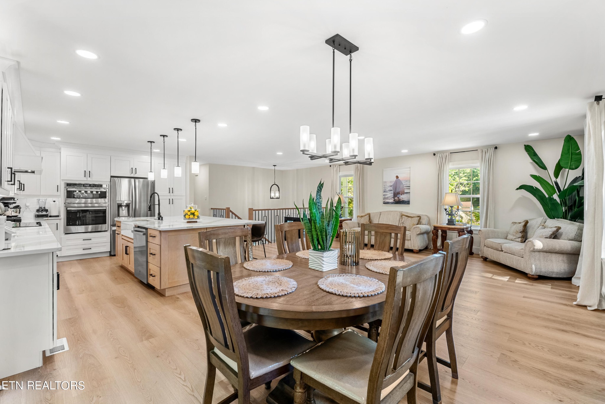 337 Farmer's Hollow Road Clinton, TN 37716 - Photo 23 of 49 a view of a dining room and livingroom with furniture wooden floor a chandelier