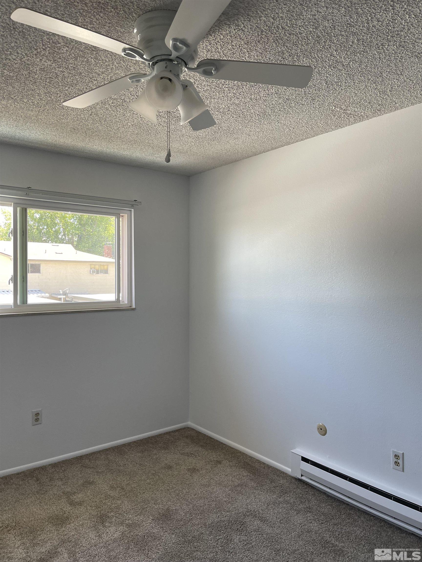 325 Smithridge Park Reno, NV 89502 - Photo 13 of 16 an empty room with a window and a fan