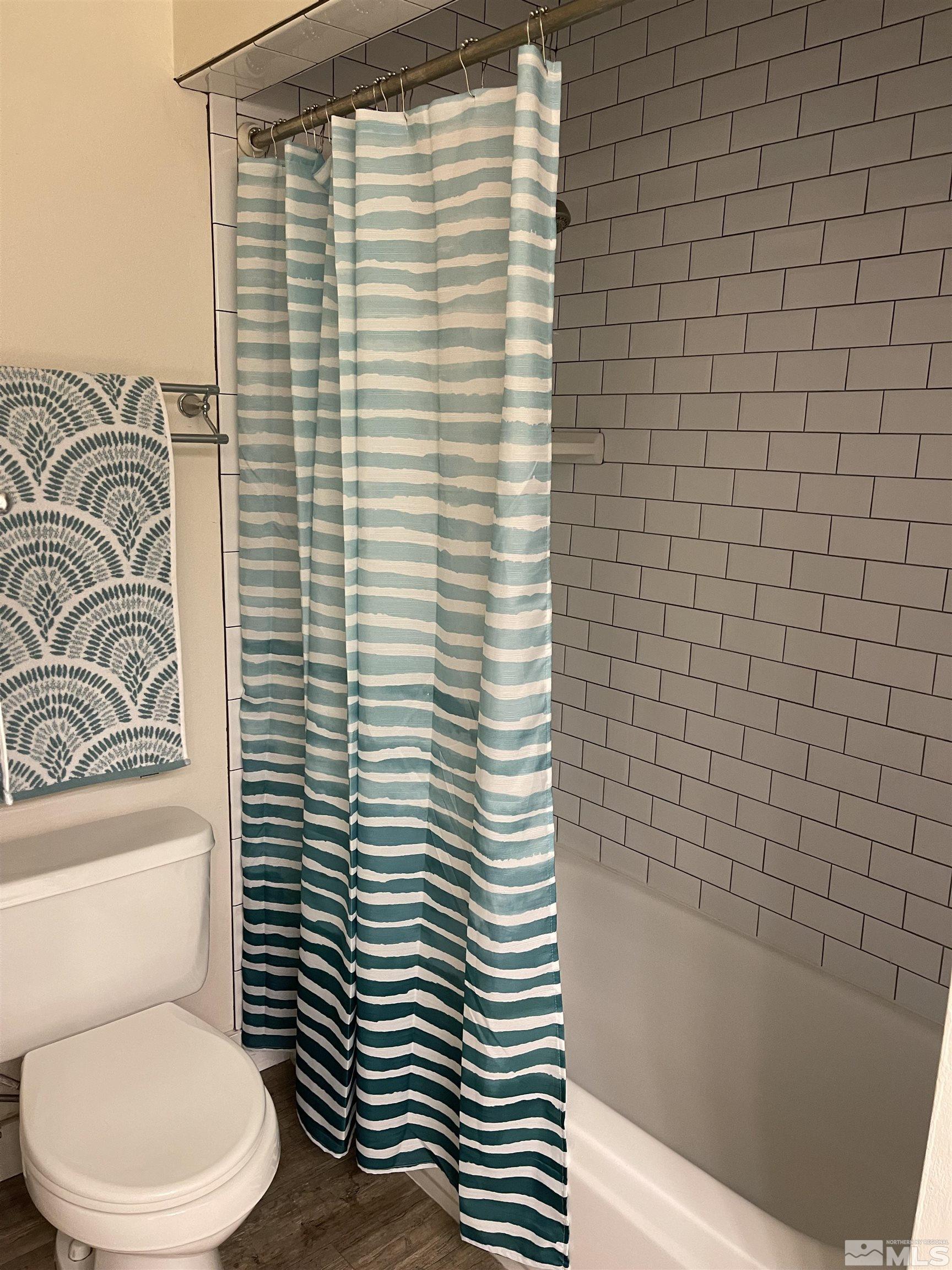 325 Smithridge Park Reno, NV 89502 - Photo 14 of 16 a bathroom with a toilet a sink and a bathtub