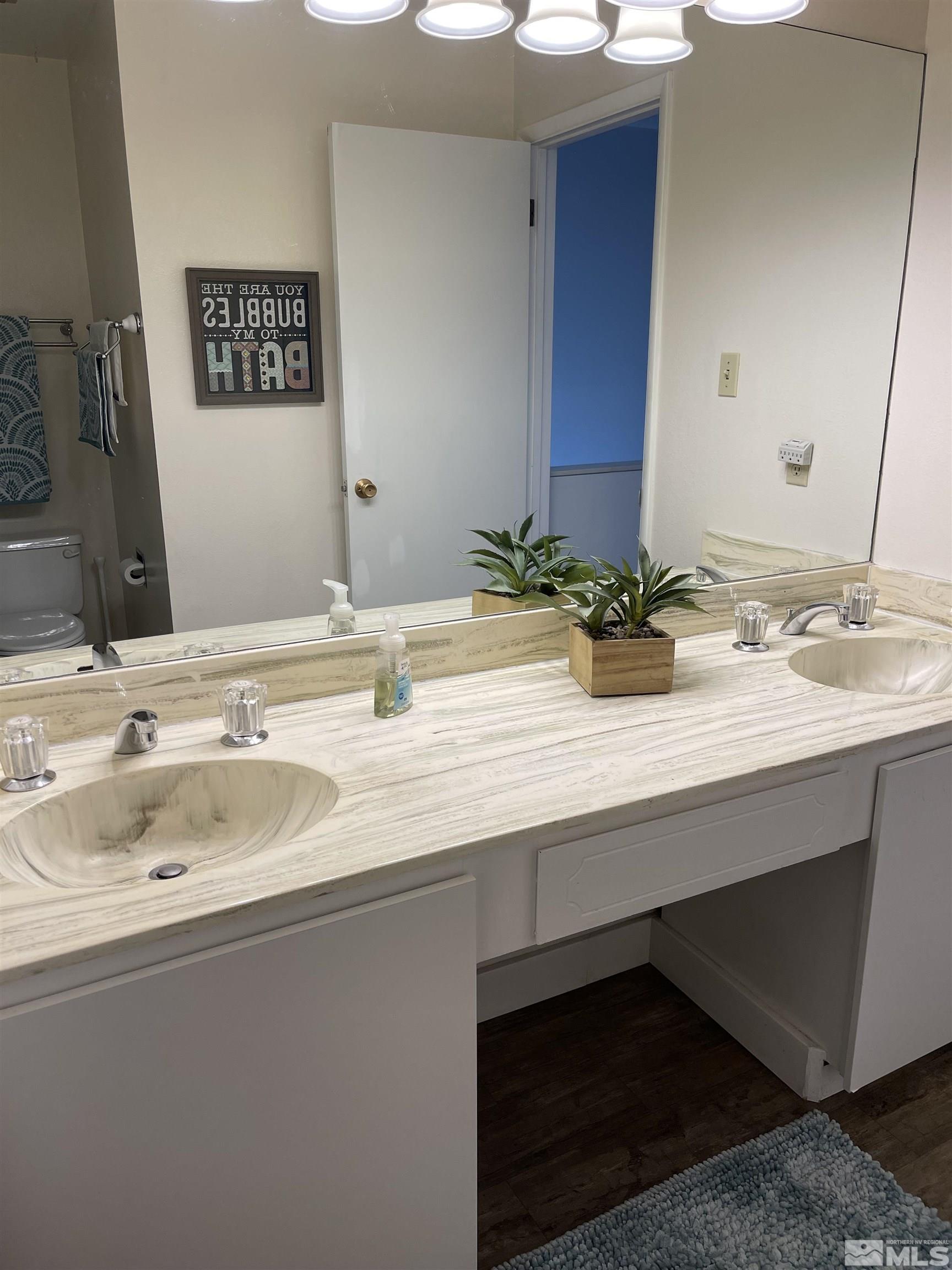 325 Smithridge Park Reno, NV 89502 - Photo 15 of 16 a bathroom with a sink and a mirror