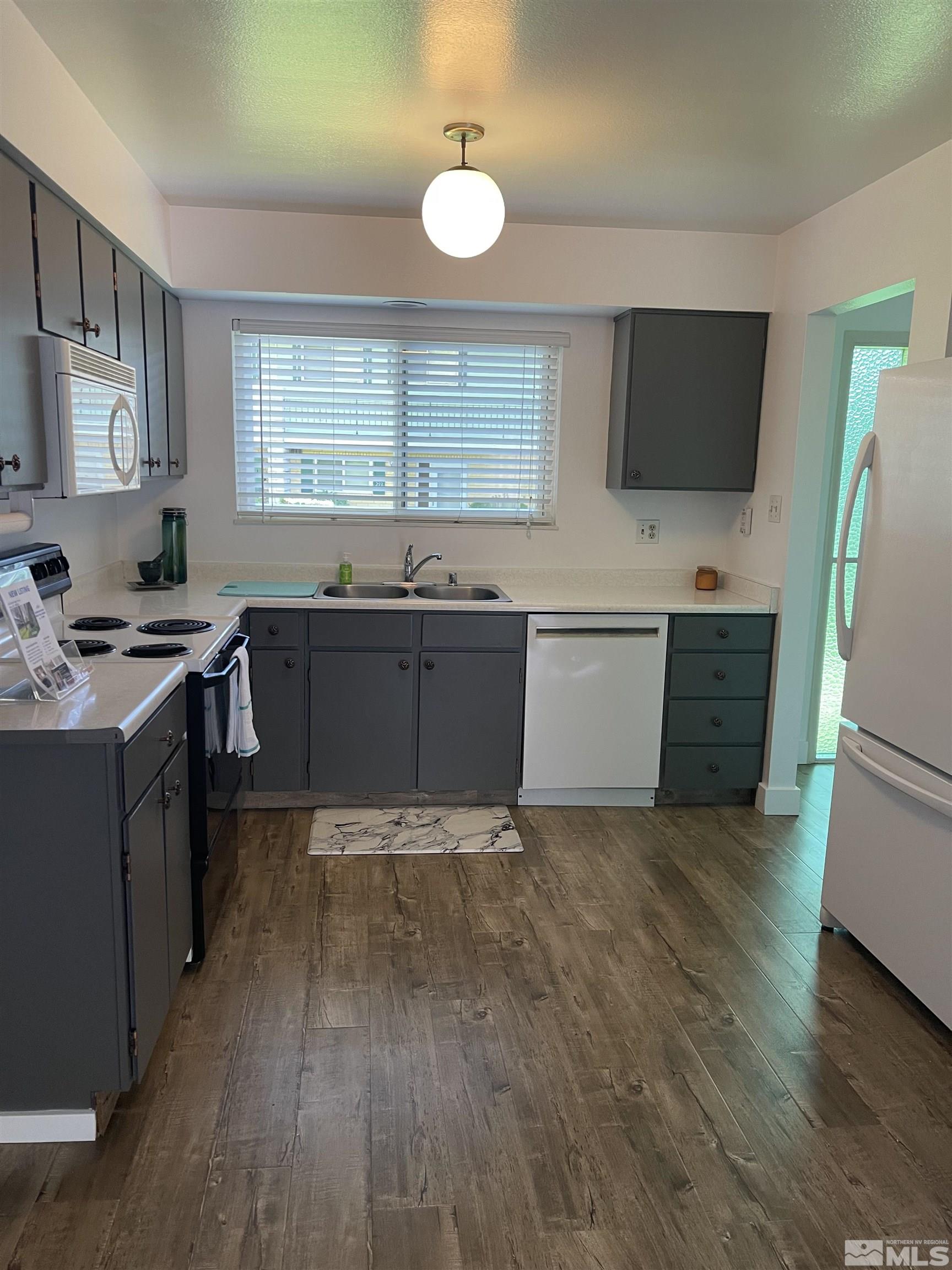 325 Smithridge Park Reno, NV 89502 - Photo 2 of 16 a kitchen with stainless steel appliances granite countertop a sink stove and microwave