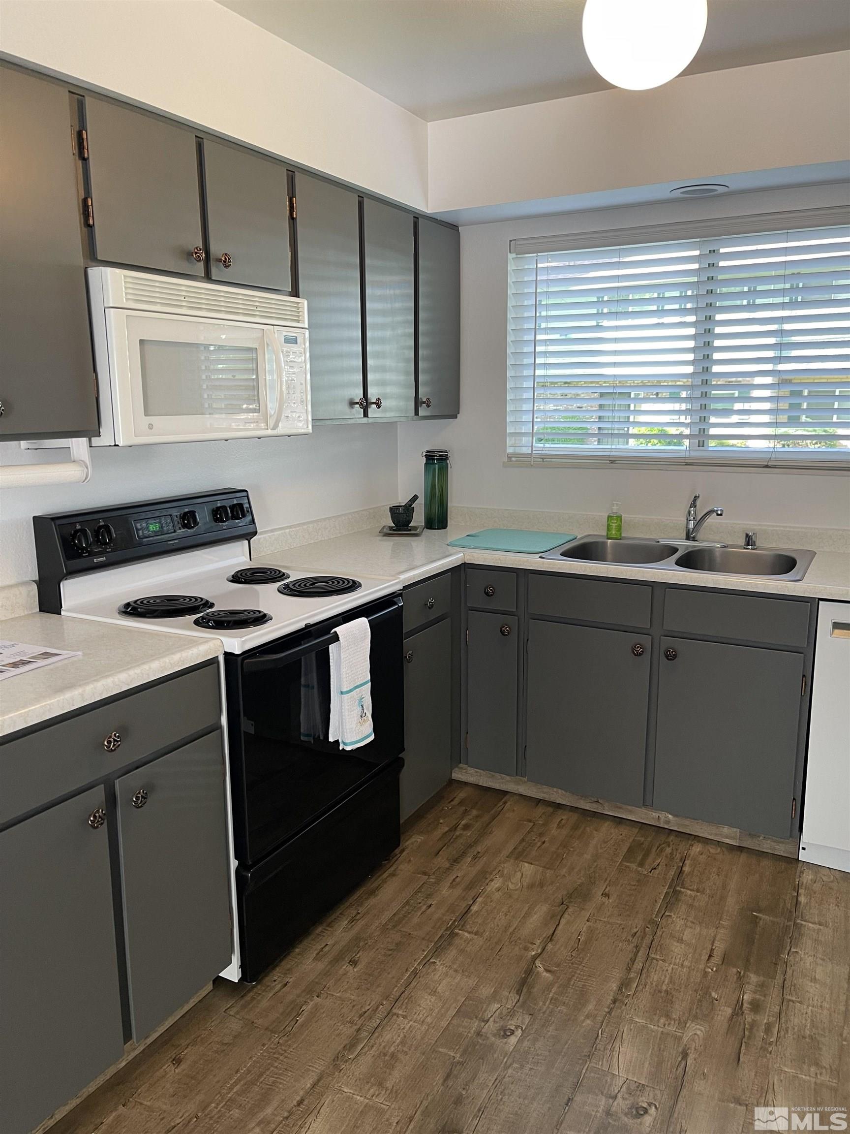 325 Smithridge Park Reno, NV 89502 - Photo 3 of 16 a kitchen with a sink cabinets and stainless steel appliances