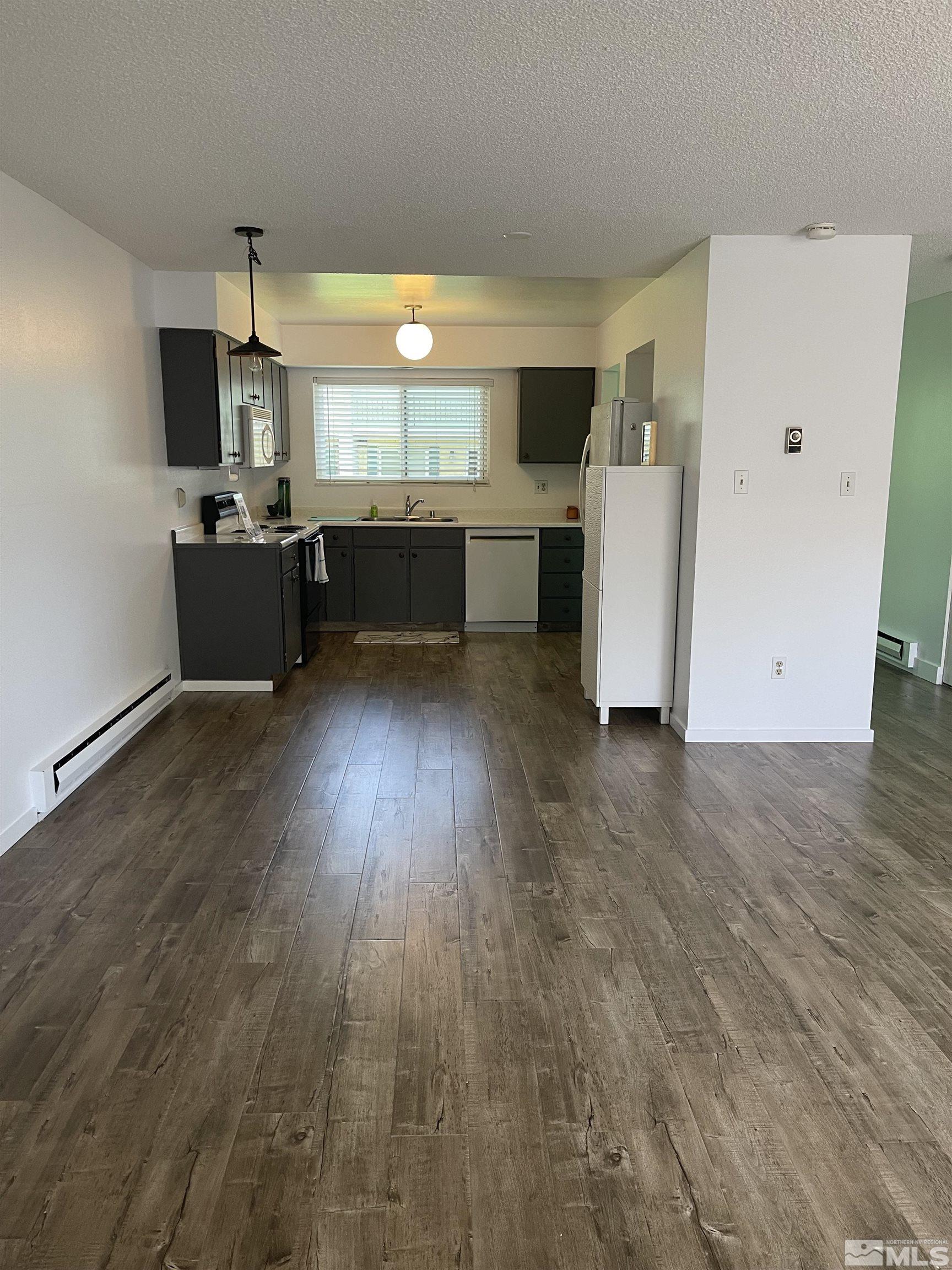 325 Smithridge Park Reno, NV 89502 - Photo 5 of 16 a view of a kitchen with a sink and wooden floor