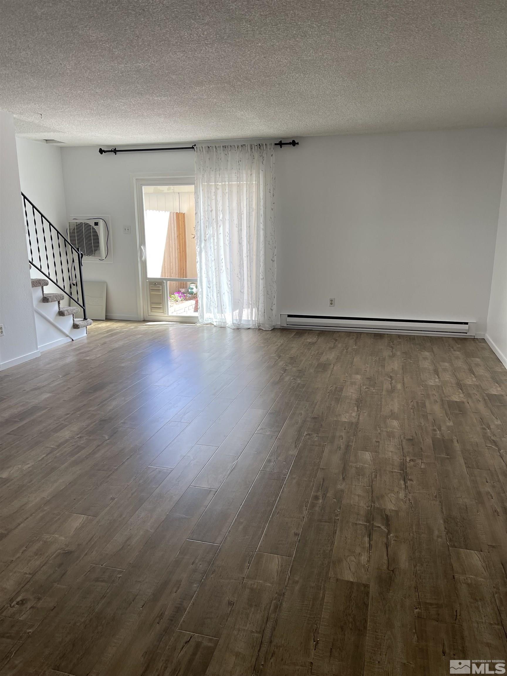 325 Smithridge Park Reno, NV 89502 - Photo 6 of 16 an empty room with wooden floor and windows